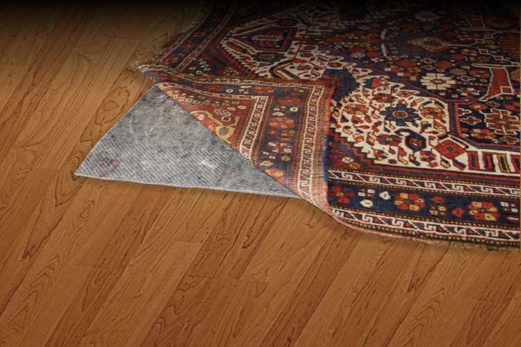 Rug pad under a rug on a wood floor